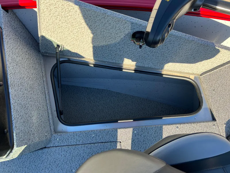 Slide: The Image of 2025 Lund 1775 Adventure Sport boat storage compartment, open and empty. - 9