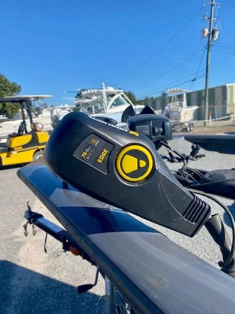 Slide: The Image of 2014 Bass Tracker PRO TEAM 190 boat with trolling motor in a marina setting. - 6