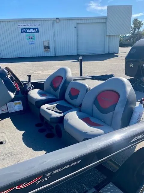 Slide: The Image of 2014 Bass Tracker PRO TEAM 190 boat interior with gray and red seating. - 13