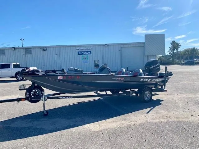 Slide: The Image of 2014 Bass Tracker PRO TEAM 190 boat on trailer in parking lot. - 4