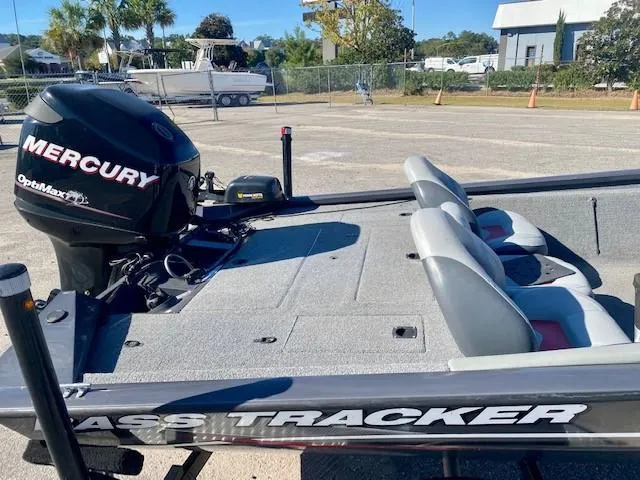 Slide: The Image of 2014 Bass Tracker PRO TEAM 190 boat with Mercury engine, parked outdoors. - 9