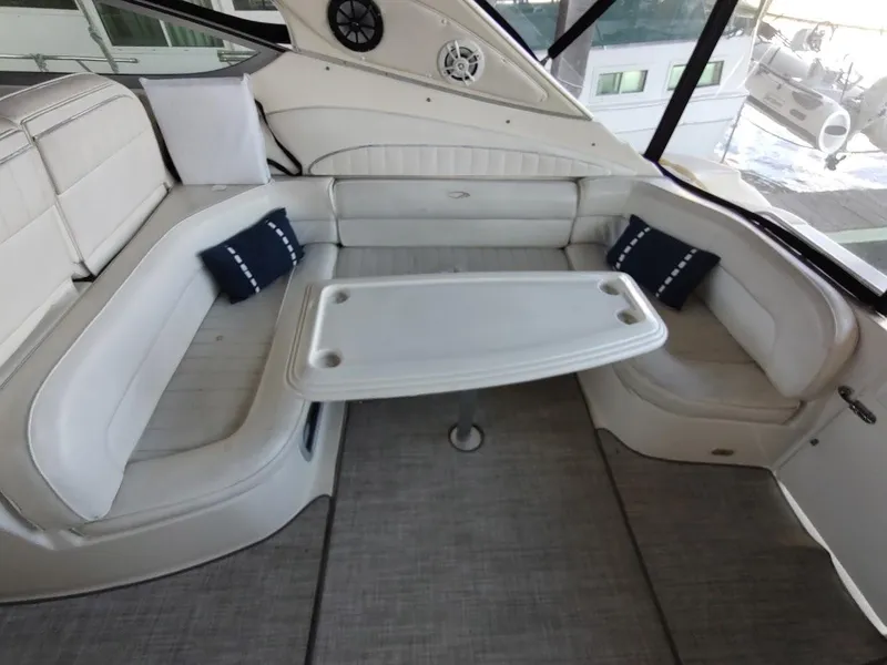 Slide: The Image of 1999 Maxum 4100 SCR yacht interior with white seating and table. - 11