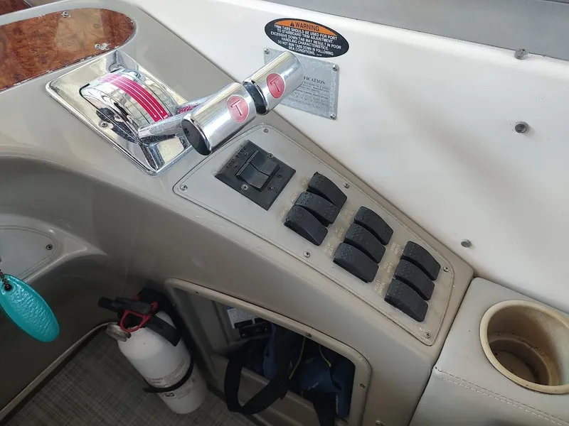 Slide: The Image of Control panel of a 1999 Maxum 4100 SCR boat with throttle and switches. - 14