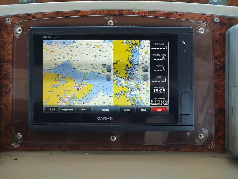 Slide: The Image of Garmin GPS display on 1999 Maxum 4100 SCR boat, showing nautical map and navigation details. - 16