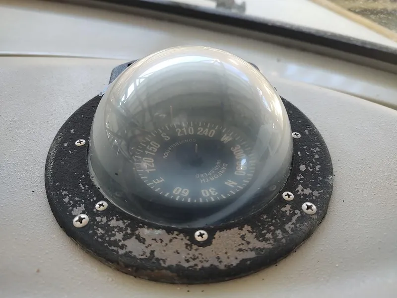 Slide: The Image of Close-up of a compass on a 1999 Maxum 4100 SCR boat dashboard. - 17