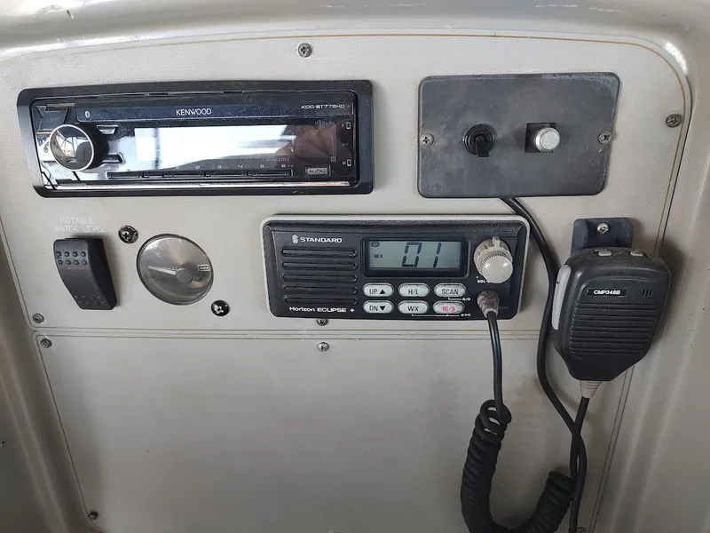 Slide: The Image of Control panel of a 1999 Maxum 4100 SCR boat with radio and gauges. - 18