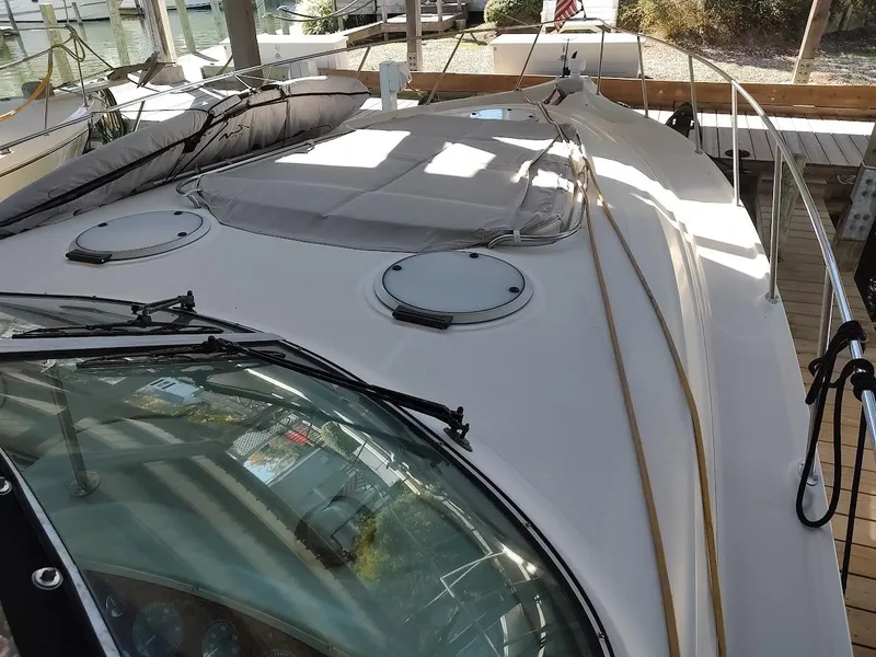 Slide: The Image of 1999 Maxum 4100 SCR yacht deck with hatches and railing in marina setting. - 20