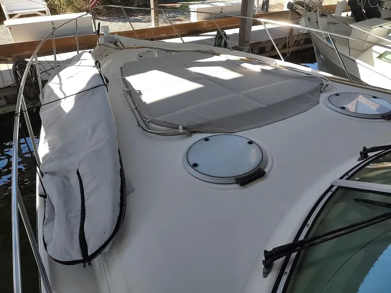 Slide: The Image of 1999 Maxum 4100 SCR yacht deck with hatches and covered equipment. - 21