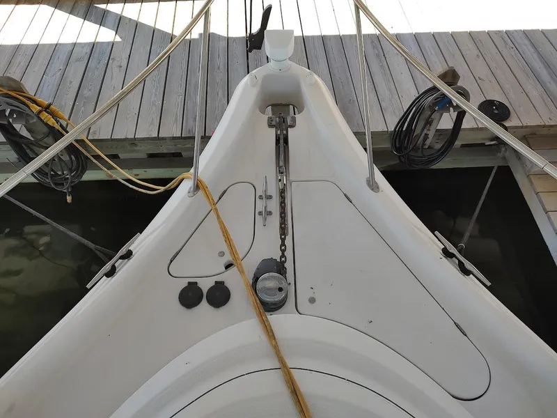 Slide: The Image of Bow of 1999 Maxum 4100 SCR yacht docked, showing anchor chain and deck details. - 22