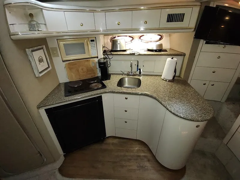 Slide: The Image of Luxurious 1999 Maxum 4100 SCR yacht kitchen with modern amenities and sleek design. - 28