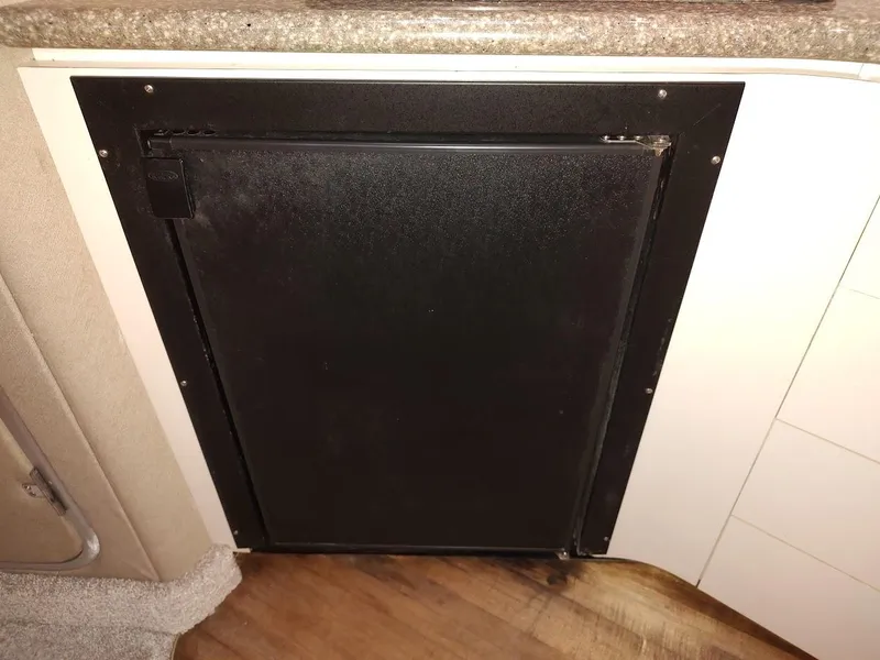 Slide: The Image of Black cabinet door in a 1999 Maxum 4100 SCR boat interior. - 32