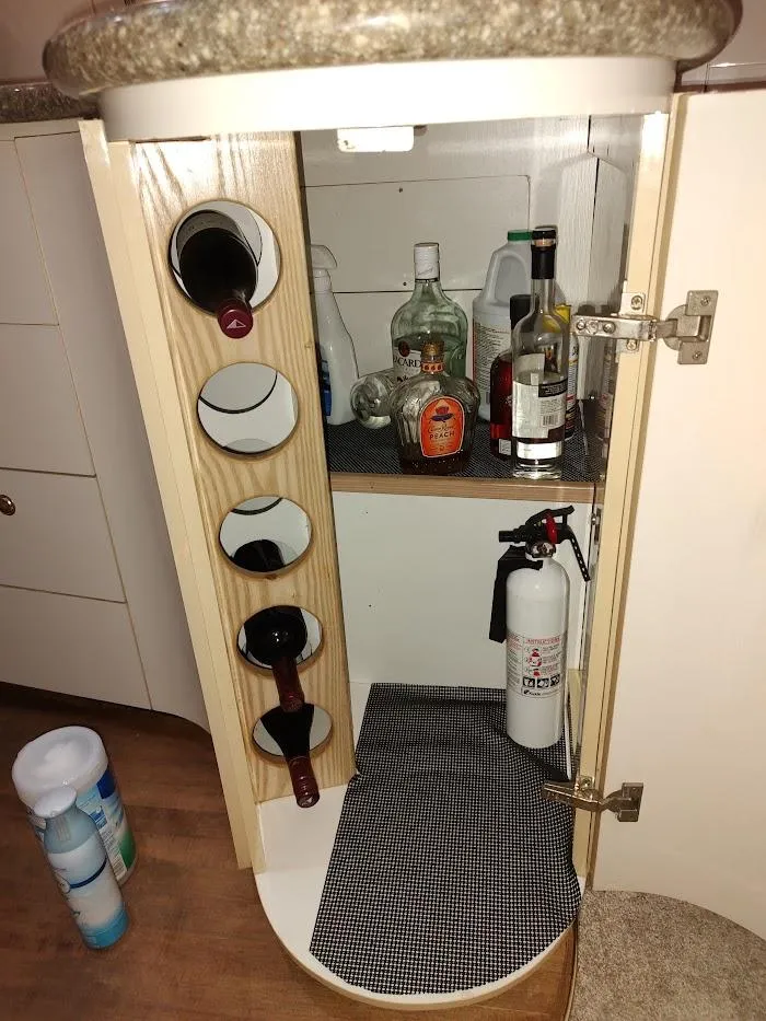 Slide: The Image of Cabinet with wine rack and fire extinguisher in 1999 Maxum 4100 SCR boat. - 35