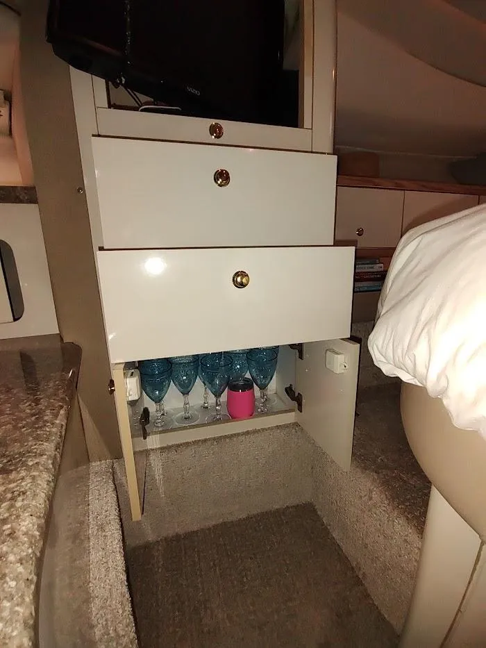 Slide: The Image of Interior of 1999 Maxum 4100 SCR yacht with open cabinet displaying glassware. - 41