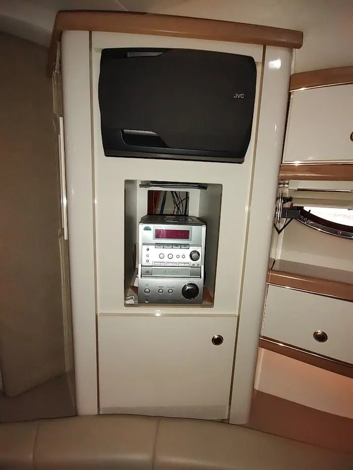 Slide: The Image of Entertainment system in 1999 Maxum 4100 SCR boat interior, featuring JVC speaker and stereo. - 44