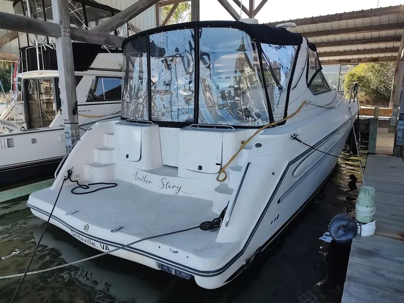 Slide: The Image of 1999 Maxum 4100 SCR yacht docked in a marina, rear view. - 5
