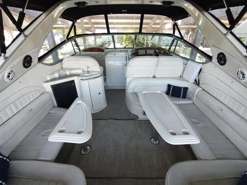 Slide: The Image of Interior of a 1999 Maxum 4100 SCR yacht with white seating and tables. - 6