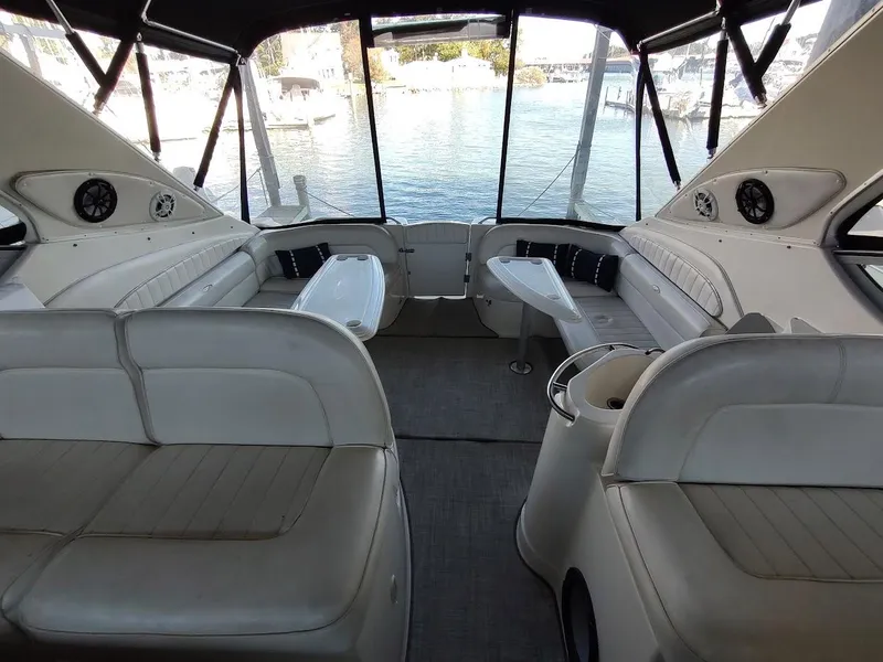 Slide: The Image of Interior of 1999 Maxum 4100 SCR yacht with spacious seating and waterfront view. - 7