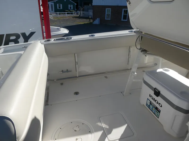 Slide: The Image of 2025 Boston Whaler 230 Outrage boat interior with seating and cooler. - 12