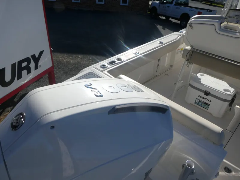 Slide: The Image of Boston Whaler 230 Outrage 2025 boat interior with engine and cooler. - 2