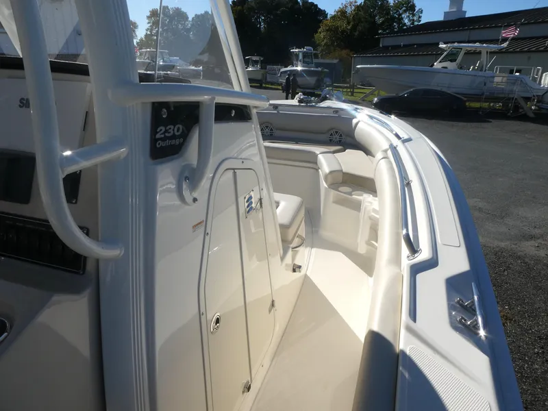 Slide: The Image of 2025 Boston Whaler 230 Outrage boat interior with seating and storage. - 6