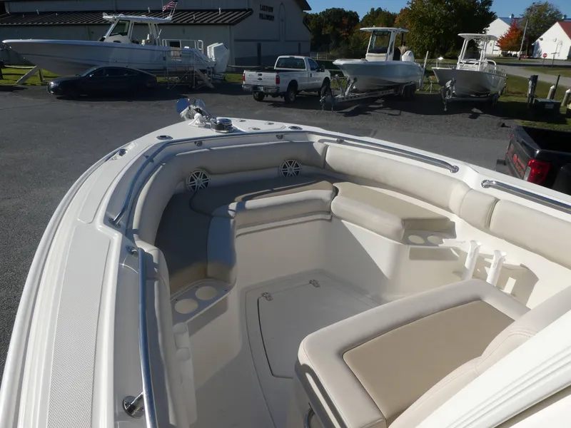 Slide: The Image of 2025 Boston Whaler 230 Outrage boat interior with cushioned seating and cup holders. - 7