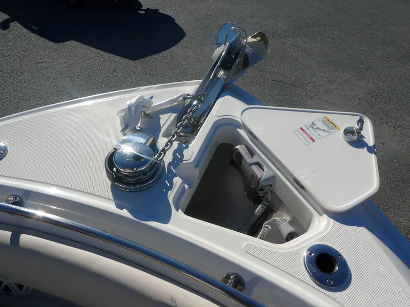 Slide: The Image of Boston Whaler 230 Outrage 2025 anchor system on deck, featuring storage compartment. - 8