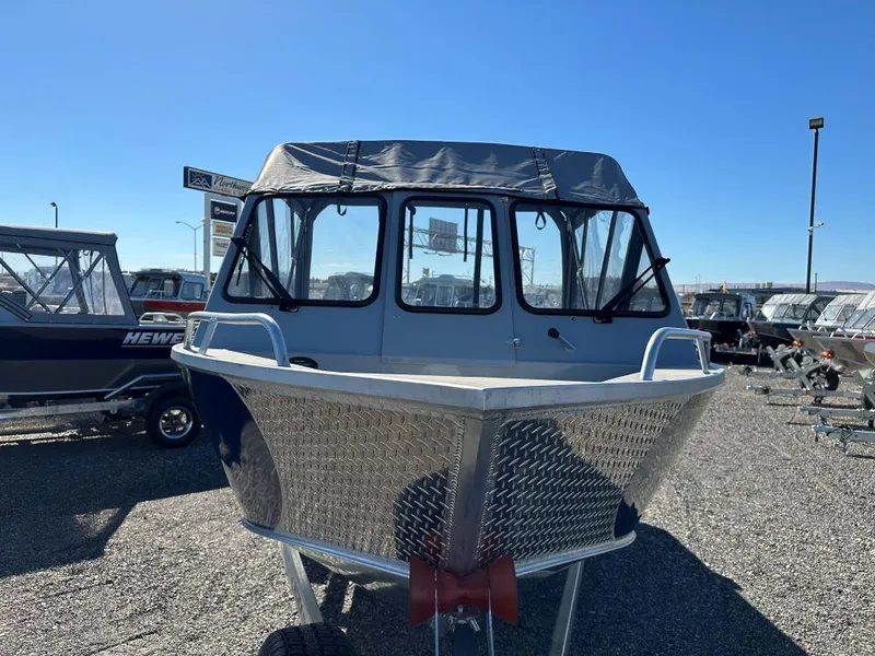 Slide: The Image of 2025 Hewescraft 200 ProV ET boat with aluminum hull in a dealership lot. - 2