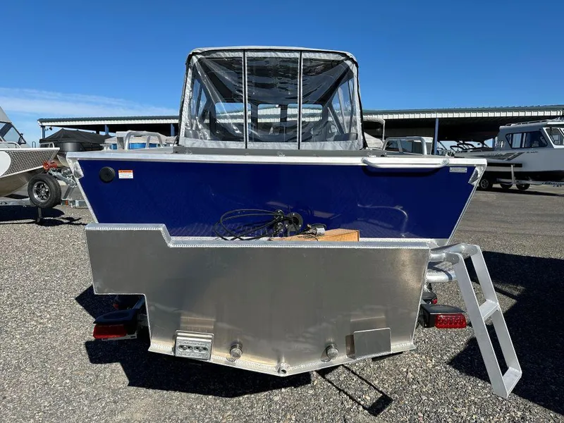 Slide: The Image of 2025 Hewescraft 200 ProV ET boat, rear view, parked outdoors. - 3