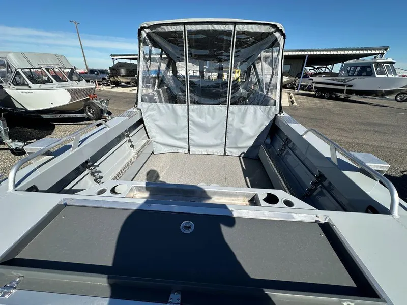 Slide: The Image of 2025 Hewescraft 200 ProV ET boat with covered cabin, parked outdoors. - 4