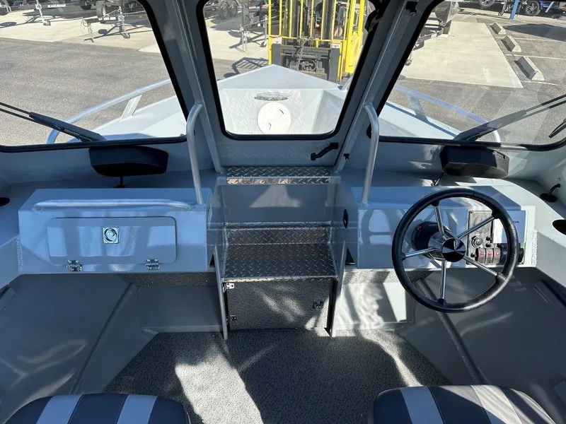 Slide: The Image of Interior view of 2025 Hewescraft 200 ProV ET boat cockpit with steering wheel and seating. - 6