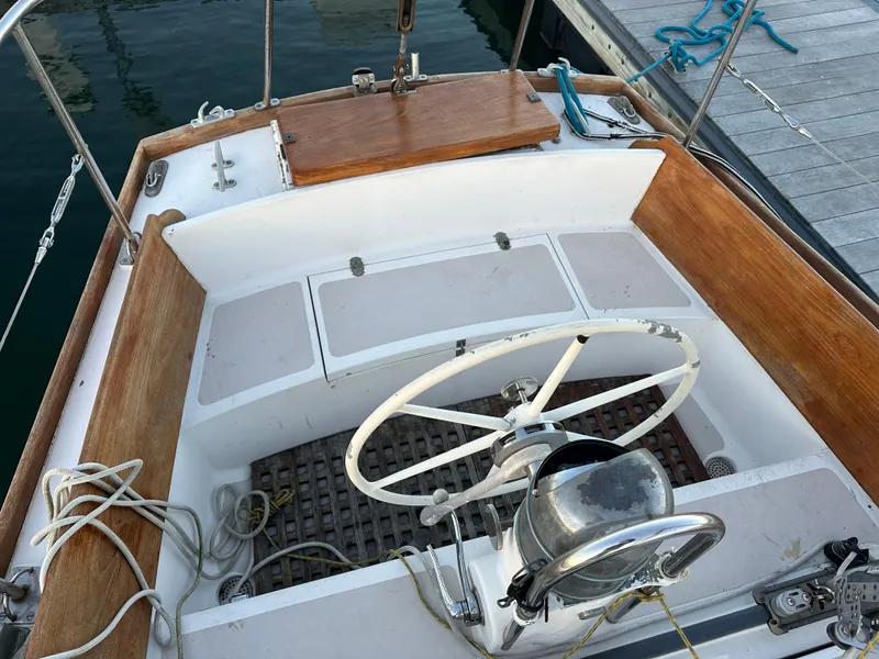 Slide: The Image of 1970 Hinckley 38 sailboat cockpit with wooden accents and steering wheel. - 10