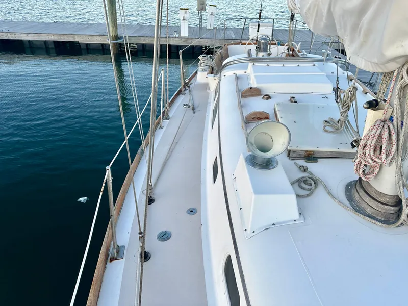 Slide: The Image of 1970 Hinckley 38 sailboat docked, showcasing deck and rigging details. - 12