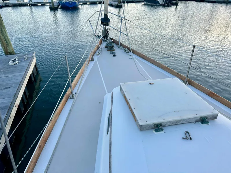 Slide: The Image of Hinckley 38 sailboat deck, 1970 model, docked at marina with calm water. - 16