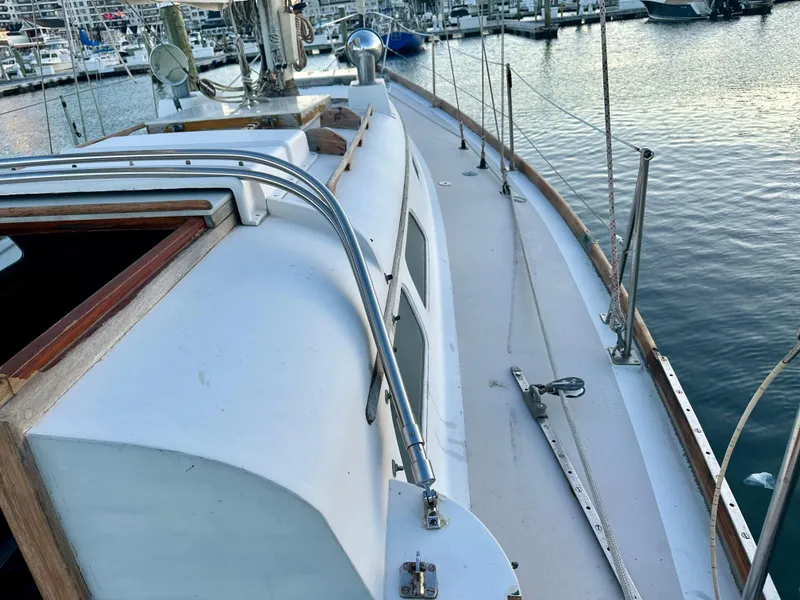 Slide: The Image of 1970 Hinckley 38 sailboat deck view at marina, showcasing classic design and craftsmanship. - 18