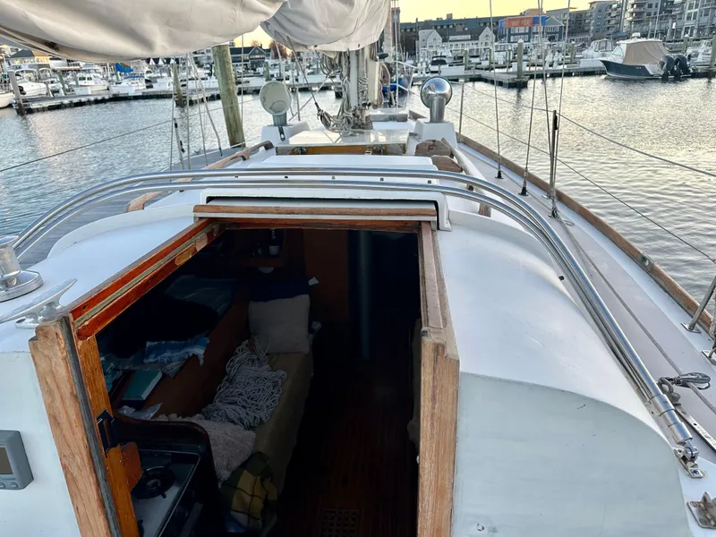 Slide: The Image of 1970 Hinckley 38 sailboat deck view with open cabin, docked at marina. - 19
