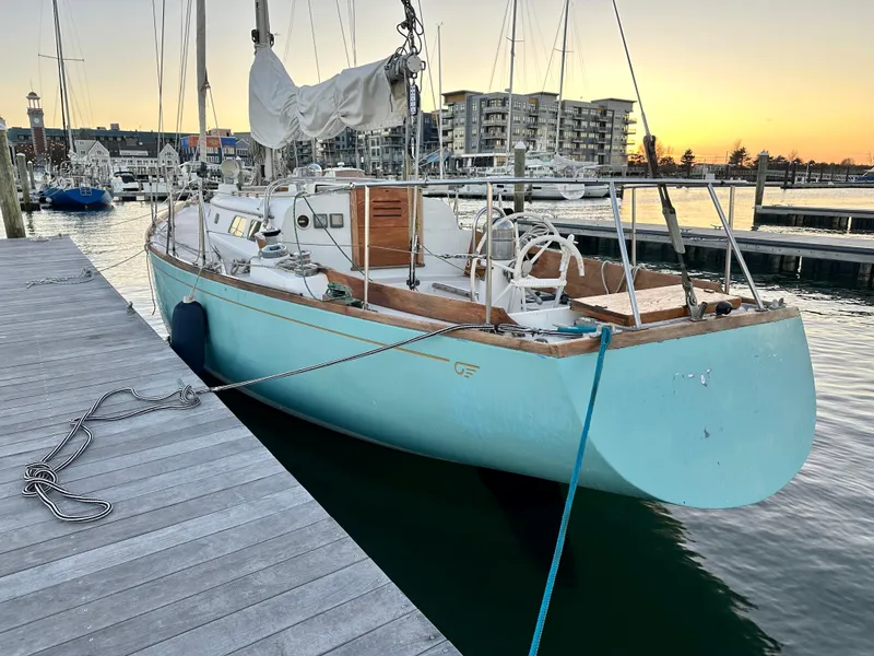 Slide: The Image of 1970 Hinckley 38 sailboat docked at marina during sunset. - 5