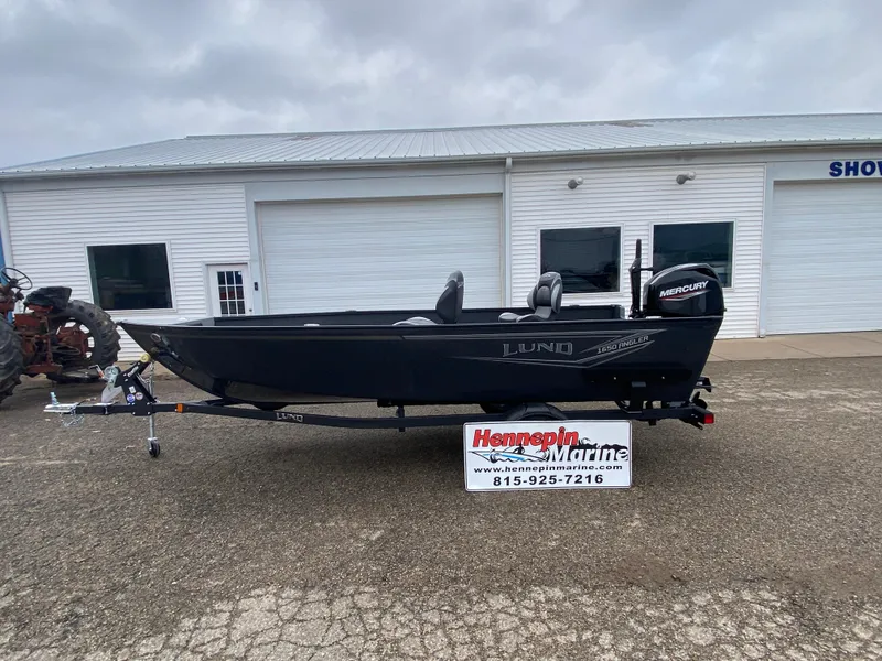 Slide: The Image of 2025 Lund 1650 Angler Tiller boat on trailer outside dealership. - 0