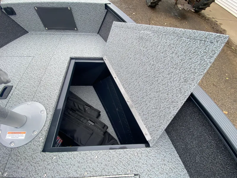 Slide: The Image of 2025 Lund 1650 Angler Tiller boat with open storage compartment. - 11