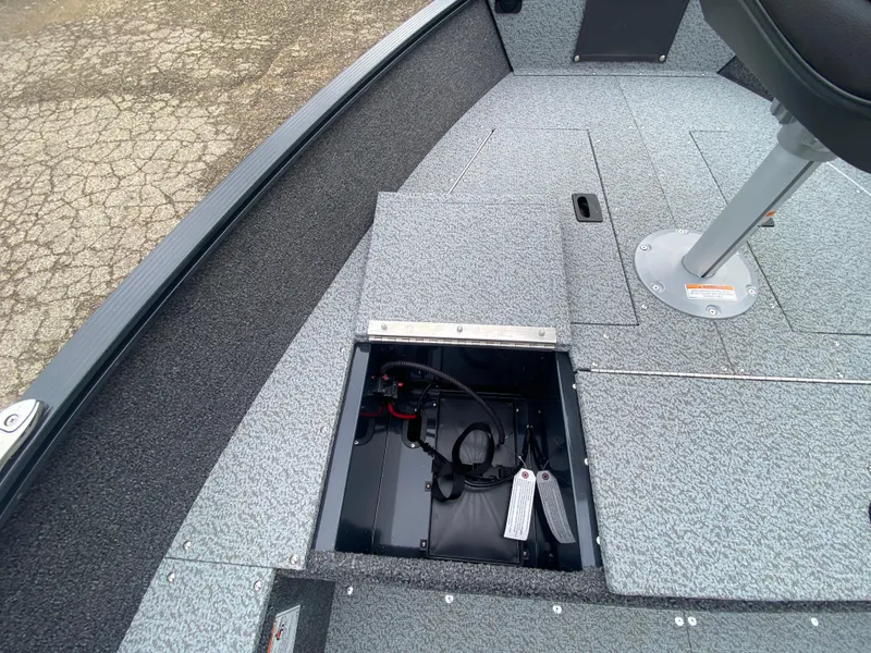 Slide: The Image of 2025 Lund 1650 Angler Tiller boat interior with open storage compartment. - 13