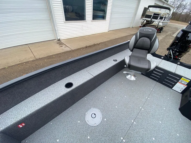 Slide: The Image of 2025 Lund 1650 Angler Tiller boat interior with seating and storage compartments. - 14