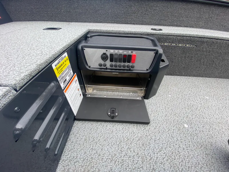 Slide: The Image of 2025 Lund 1650 Angler Tiller boat control panel with storage compartment. - 21