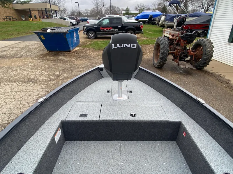 Slide: The Image of 2025 Lund 1650 Angler Tiller boat interior with seating and storage compartments. - 28