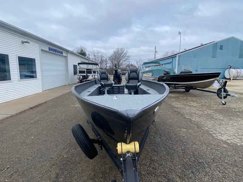 Slide: The Image of 2025 Lund 1650 Angler Tiller boat on trailer, parked outside showroom. - 6