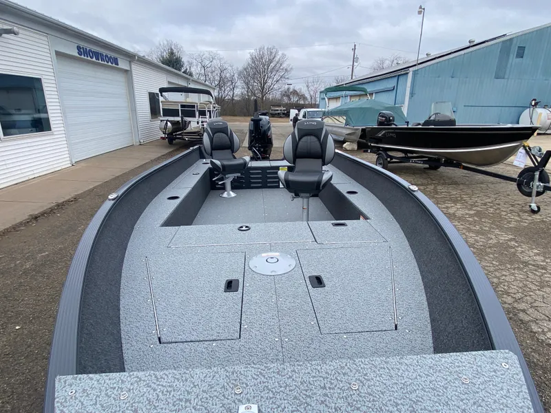 Slide: The Image of 2025 Lund 1650 Angler Tiller boat with dual seats, displayed outdoors. - 7