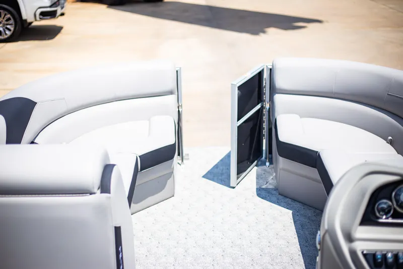 Slide: The Image of 2025 Trifecta 22RF LE2.75 pontoon boat interior with open gate and plush seating. - 4