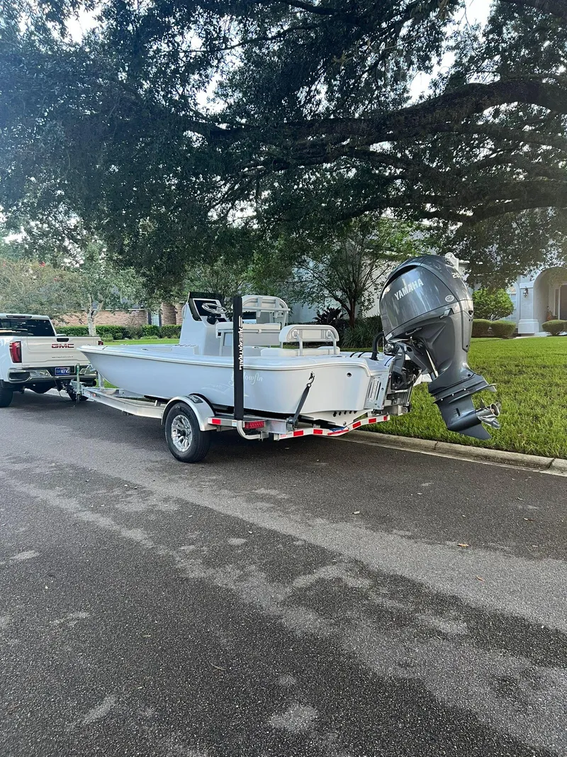 Slide: The Image of 2025 Yellowfin 21 Bay boat on trailer, parked on residential street. - 3