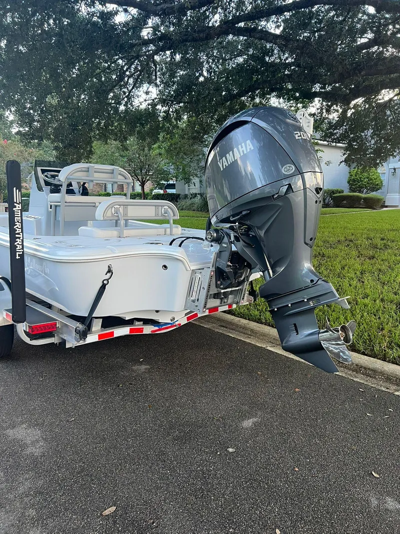 Slide: The Image of 2025 Yellowfin 21 Bay boat with Yamaha outboard engine on trailer. - 4