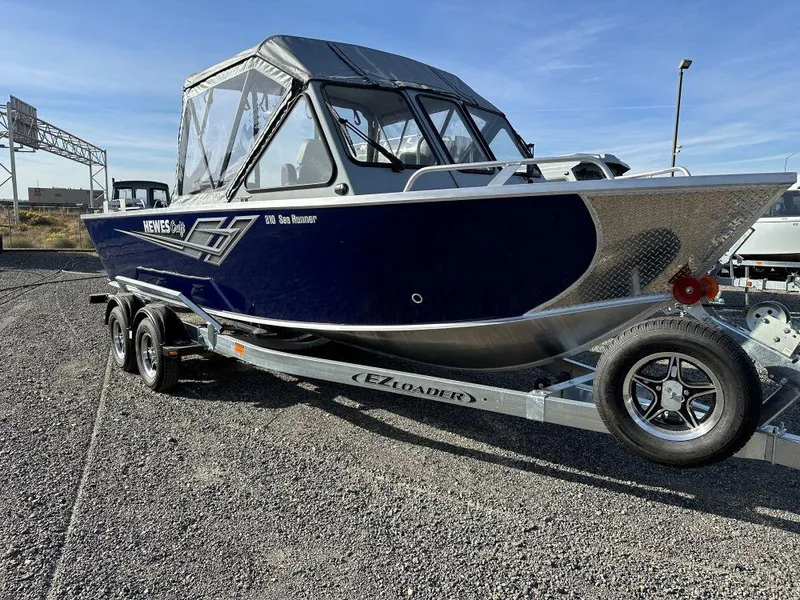 Slide: The Image of 2025 Hewescraft 210 Sea Runner ET boat on trailer, side view. - 0