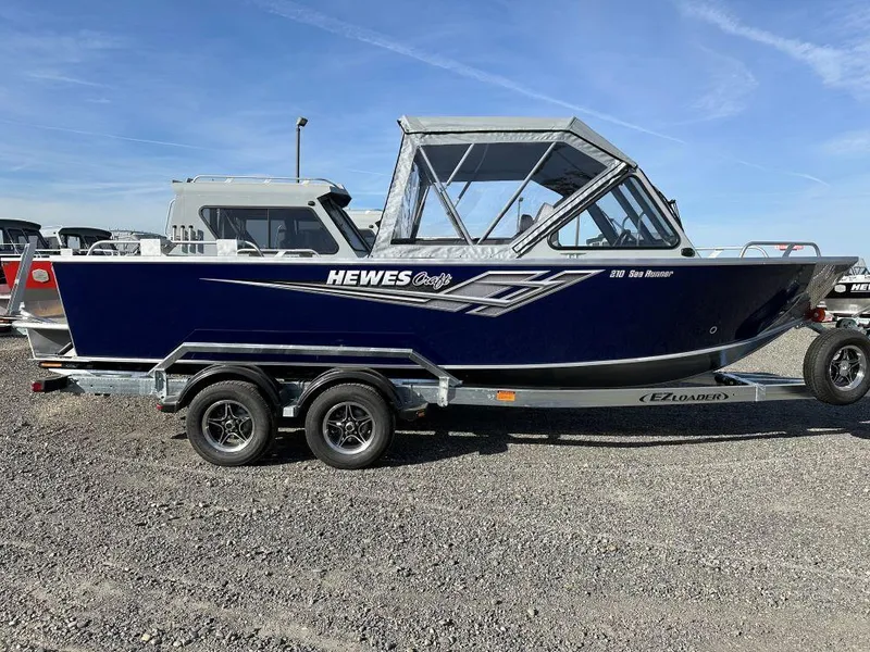 Slide: The Image of 2025 Hewescraft 210 Sea Runner ET boat on trailer, side view. - 1
