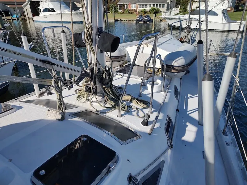 Slide: The Image of Sailboat deck of 1997 Hylas 46 with rigging and lifeboat, docked in marina. - 10